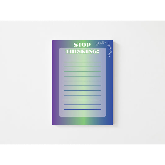 Notepad with gradient cover and motivational text on a white background